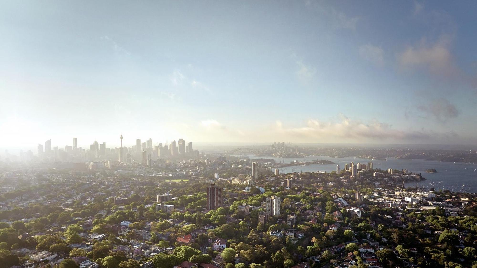Meriton Suites Bondi Junction Sydney Bagian luar foto The photo shows a panoramic view of a city skyline, likely taken from a high vantage point. In the foreground, there are lush green trees and buildings, suggesting a suburban area. As the view extends towards the background, tall skyscrapers dominate